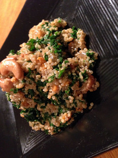 A picture of quinoa and kale salad with cherry lemon vinagrette.