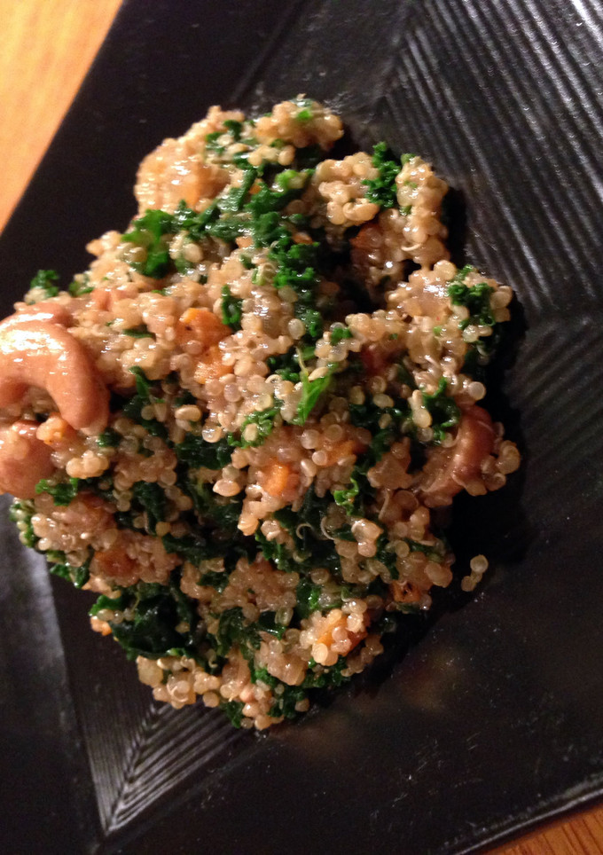 A picture of quinoa and kale salad with cherry lemon vinagrette.