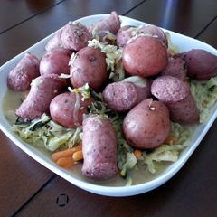 A picture of Polish Wedding Sausage with Cabbage and Red Potatoes.