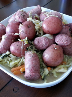 A picture of Polish Wedding Sausage with Cabbage and Red Potatoes.