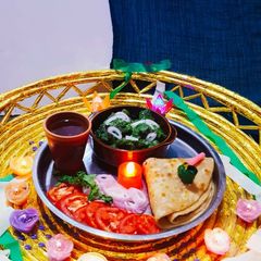 A picture of Green Mutton Curry With Lacha Paratha.
