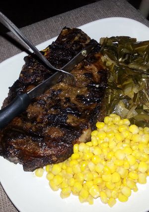 A picture of Lebanese spiced rib eye with collards and sweet&spicy corn.