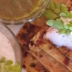 A picture of Moringa leaf and pottato stuffed shahi paratha with moringa dip.