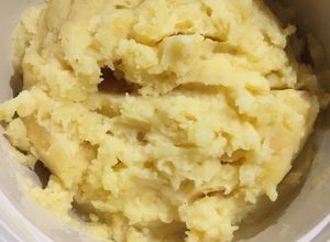 Una foto de Papas en puré con parmesano
