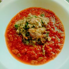 A picture of Roasted tomatoes stew garnished with fish sauce.