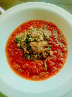 A picture of Roasted tomatoes stew garnished with fish sauce.
