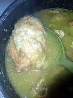 A picture of Tortitas de pollo en salsa Verde (Chicken in egg batter and green salsa).