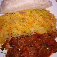 A picture of Wet fried beef, cabbage with Ugali.