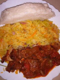 A picture of Wet fried beef, cabbage with Ugali.