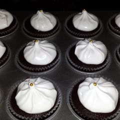 A picture of dark chocolate cupcakes w/ marshmallow frosting! yummmy :)).