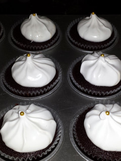 A picture of dark chocolate cupcakes w/ marshmallow frosting! yummmy :)).