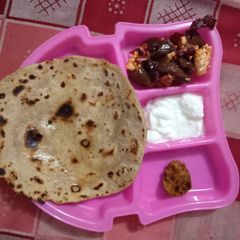 A picture of Prantha with paneer capsicum veg and curd.