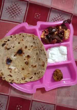 A picture of Prantha with paneer capsicum veg and curd.