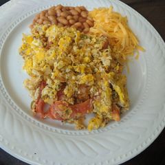 A picture of Eggs with chillies and tomatoes.
