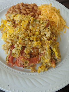 A picture of Eggs with chillies and tomatoes.