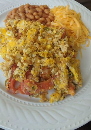 A picture of Eggs with chillies and tomatoes.