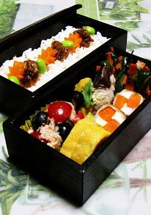 A picture of The Flavors of the Seto Inland Sea - Mackerel with Miso-Mayo in a Bento Box.