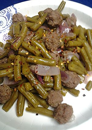 A picture of Green beans with meatballs.