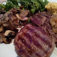 A picture of Ribeye Steak with Onion Gravy, Mushrooms & Fresh Greens.