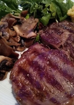 A picture of Ribeye Steak with Onion Gravy, Mushrooms & Fresh Greens.