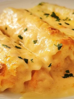 Una foto de Canelones de Merluza y Langostinos
