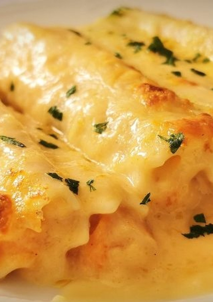 Una foto de Canelones de Merluza y Langostinos