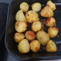 A picture of Roast potatoes with chilli flakes.