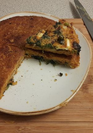 A picture of Spinach, potato and feta "tortilla" with a fried egg.