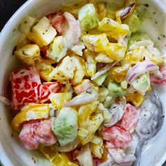 A picture of Greek salad with ranch dressing.