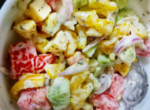A picture of Greek salad with ranch dressing.