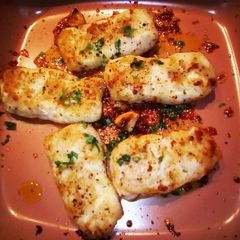 A picture of Garlic buttered Prime Hake medallions.