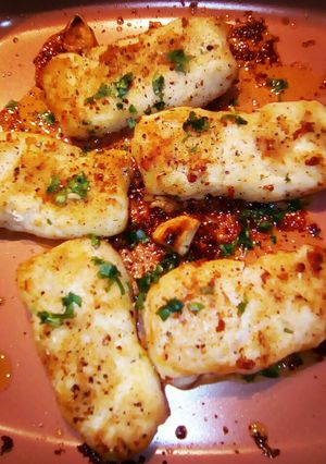 A picture of Garlic buttered Prime Hake medallions.