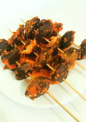 A picture of Peppered fried beef on skewer.