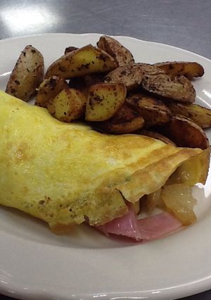 A picture of One egg omelette with home fries for one.