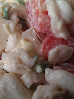 A picture of Potato salad with tomatoes.