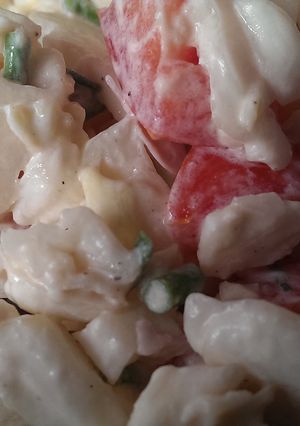 A picture of Potato salad with tomatoes.
