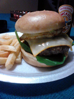 A picture of Chipotle Bacon cheeseburger topped with avocado and a fried egg.