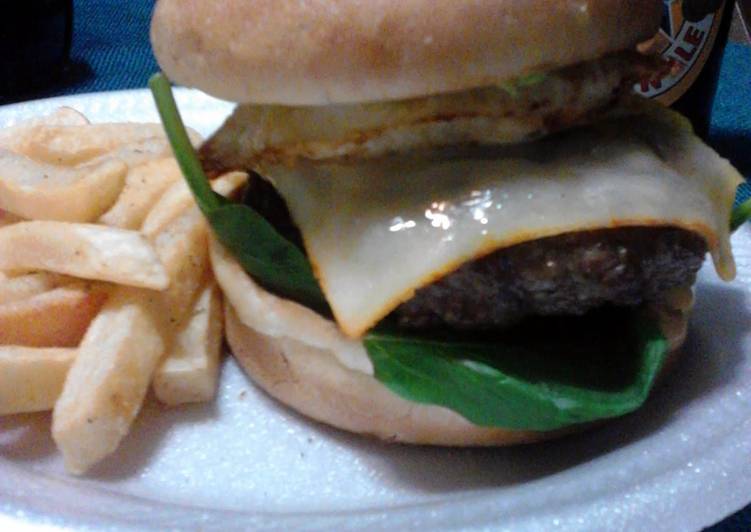 Chipotle Bacon cheeseburger topped with avocado and a fried egg