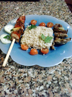 A picture of skewered pork with intire rice.