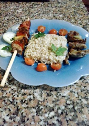 A picture of skewered pork with intire rice.