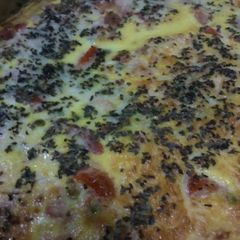 A picture of Omelette, with peas, tomatoes and ham.
