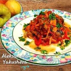 A picture of Eggplant with sweet peppers in tomato.