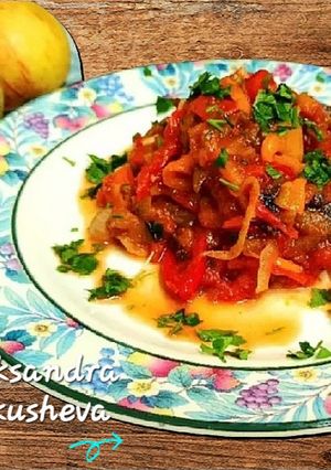 A picture of Eggplant with sweet peppers in tomato.