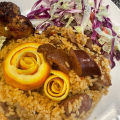 A picture of Dominican rice with pork and sausage.