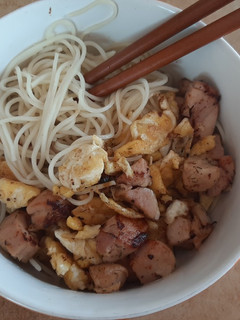 A picture of Ramen noodles with eggs and chicken.