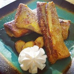 A picture of French Toast Banana Fosters Roll-Ups.