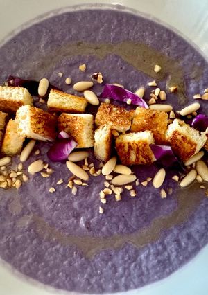 A picture of Purple Cabbage Soup with Sheep’s Milk Ricotta and Kamut Bread Croutons.