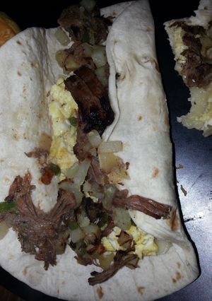 A picture of Left over roast beef breakfast burrito.