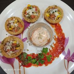 A picture of Pizza disc with brown bread on tawa.