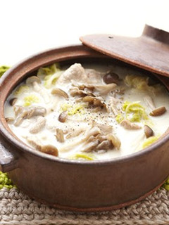A picture of Soy Milk Hot Pot with lots of Mushrooms.